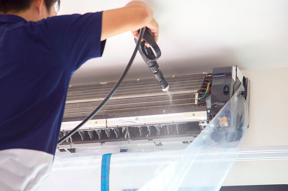 Technician performing hydro cleaning on an indoor split air conditioning unit to ensure optimal functionality and air quality.