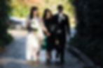 Holly and James walking together outdoors on their wedding day.
