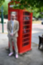 Jo standing by a red phone booth
