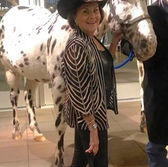 Artist June Dudley next to her horse.
