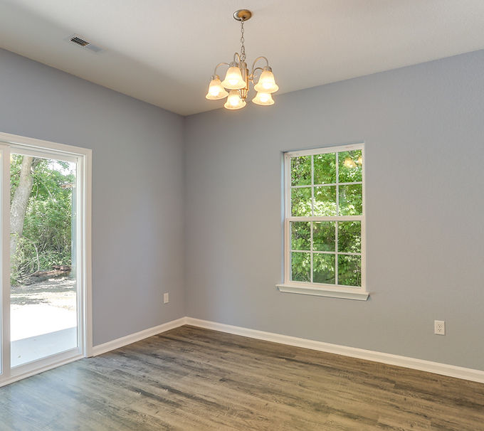 Bright dining room with sliding glass doors, hardwood floors