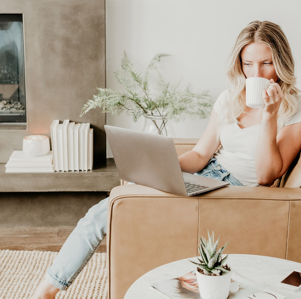 Expectant mother researching pregnancy health coaching benefits online while enjoying a cup of tea