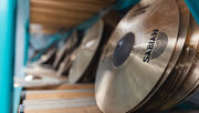 Finished Sabian cymbals stored on racks inside the factory.