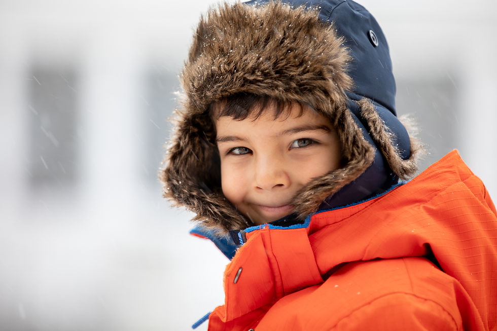 Portrait of a boy in winter gear outside.