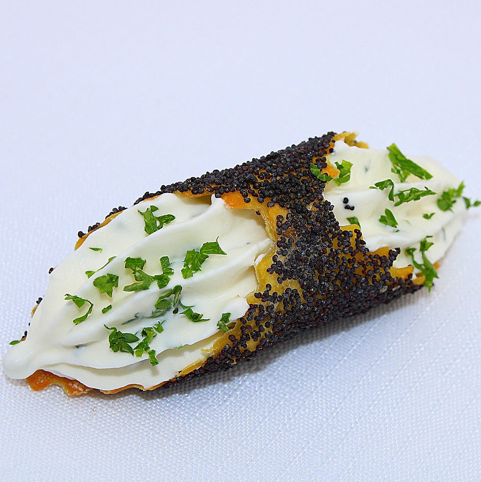 A wonton tube filled with goat cheese mousse & poppy seeds