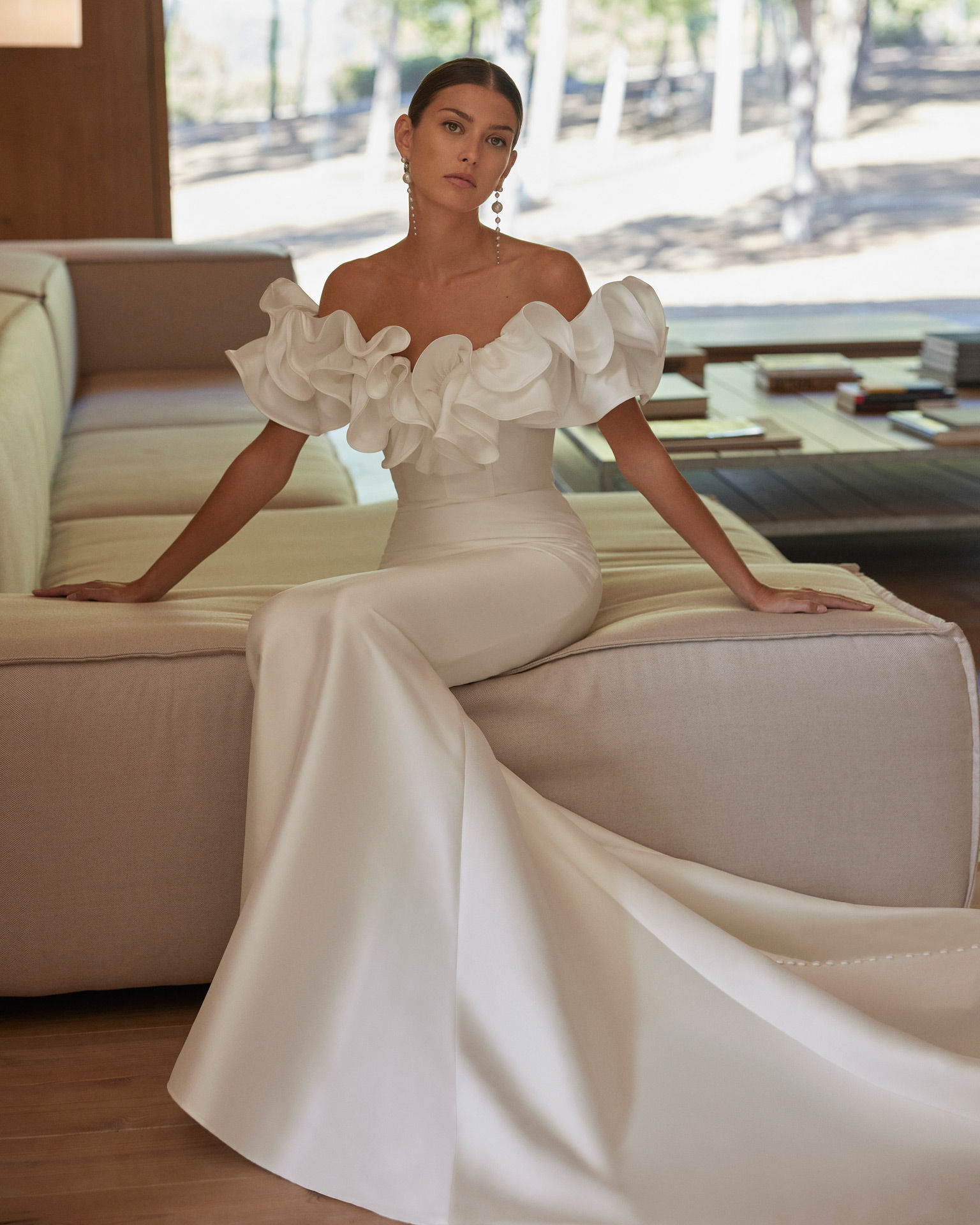 Arold Rosa Clara Dress worn by a bride sitting on the end of a sofa
