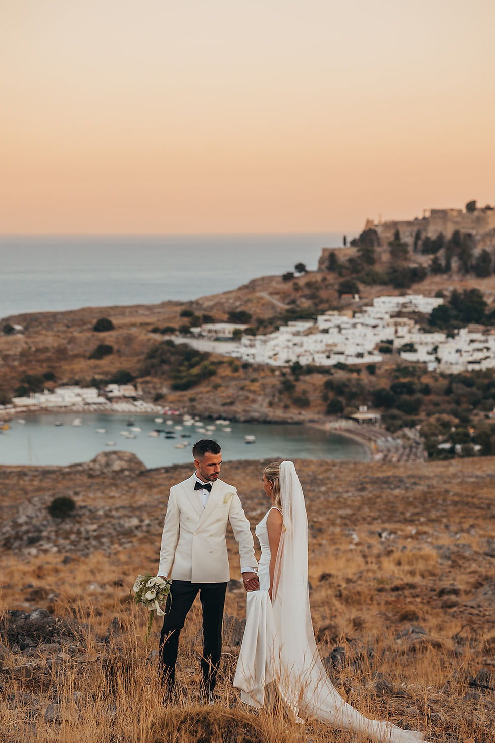 bride and groom with sea backdrop