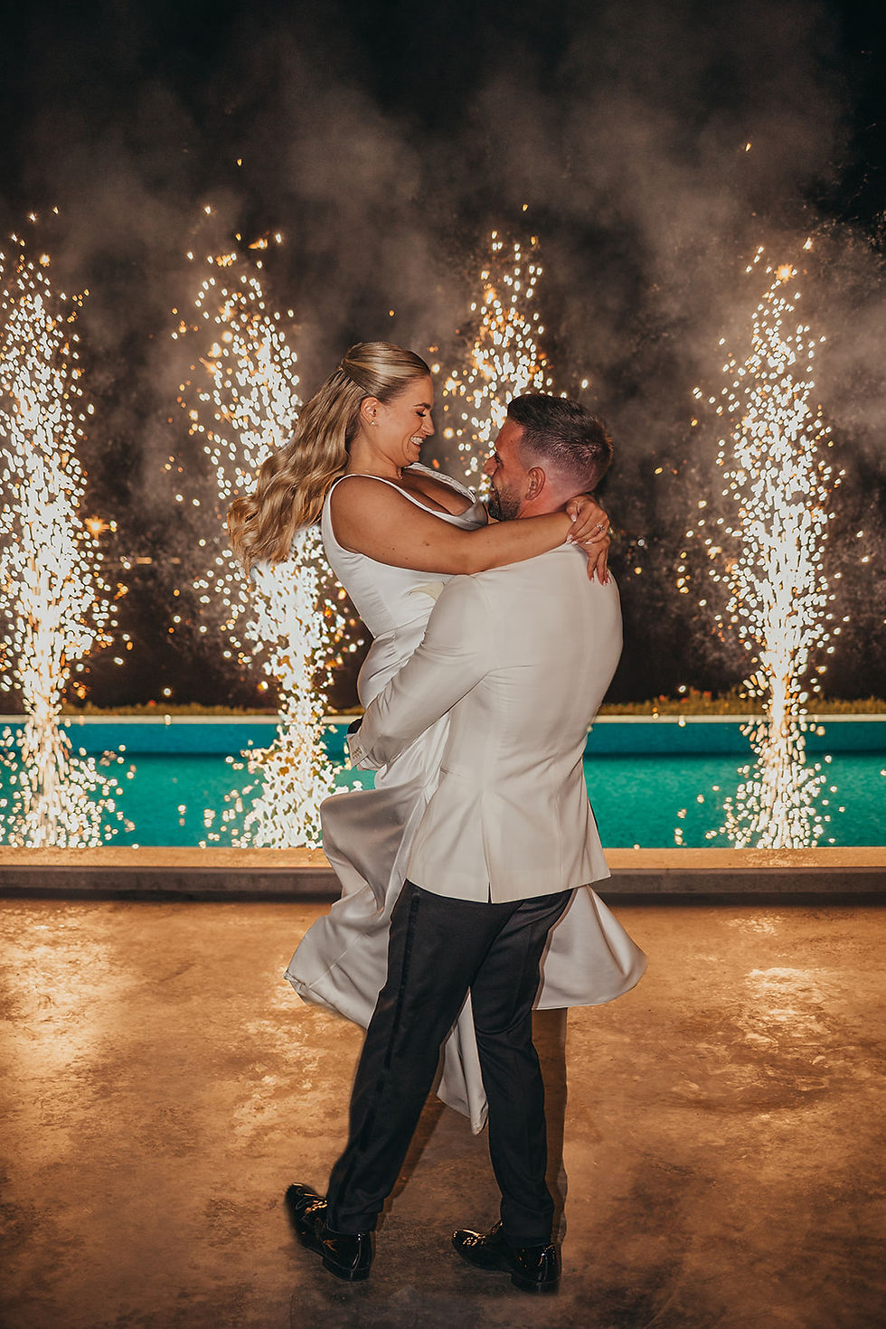 bride and groom dancing with fireworks