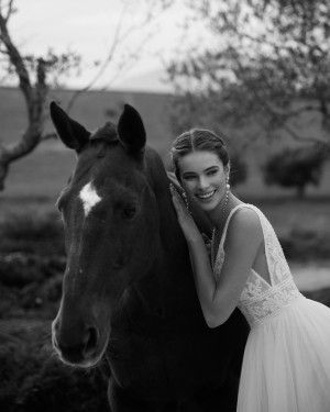 Thumbnail: Bride with a horse in a Demi wedding dress