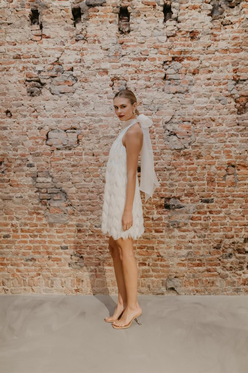 Thumbnail: Side of Bride in the Geminise Fringed Halter Neck Wedding Dress