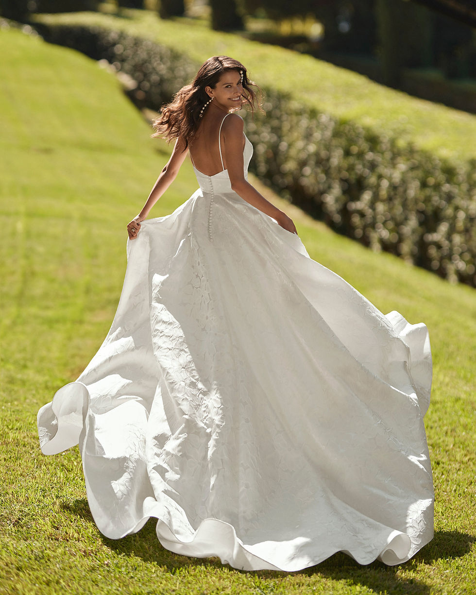 Thumbnail: Back of Bride in Donnia Wedding Dress by Adriana Alier