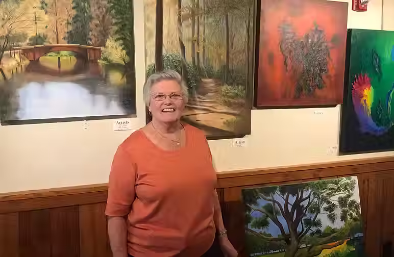 An old lady in front of great arts.