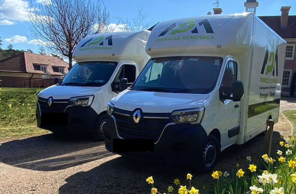 Two Pinnacle Removals and Storage vans parked whilst packers carry out a removals to Horsham job.
