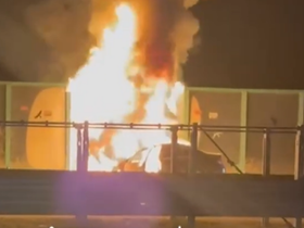 The car is engulfed in flames and completely burned