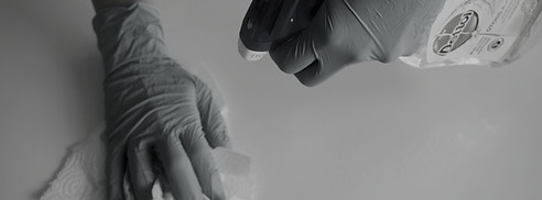 person in blue gloves holding white text