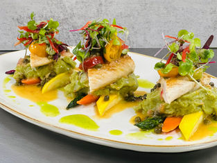 A plated entree served on a platter at an event catered by Masterpiece Cuisine.