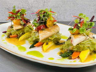 A plated entree served on a platter at an event catered by Masterpiece Cuisine.