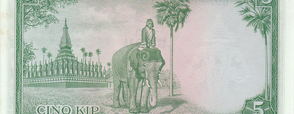 5 Kip (Kingdom Of Laos, 1962)-Reverse: Depicts a rider on a tamed Asian Elephant, backed by the Great Stupa, in Vientiane.