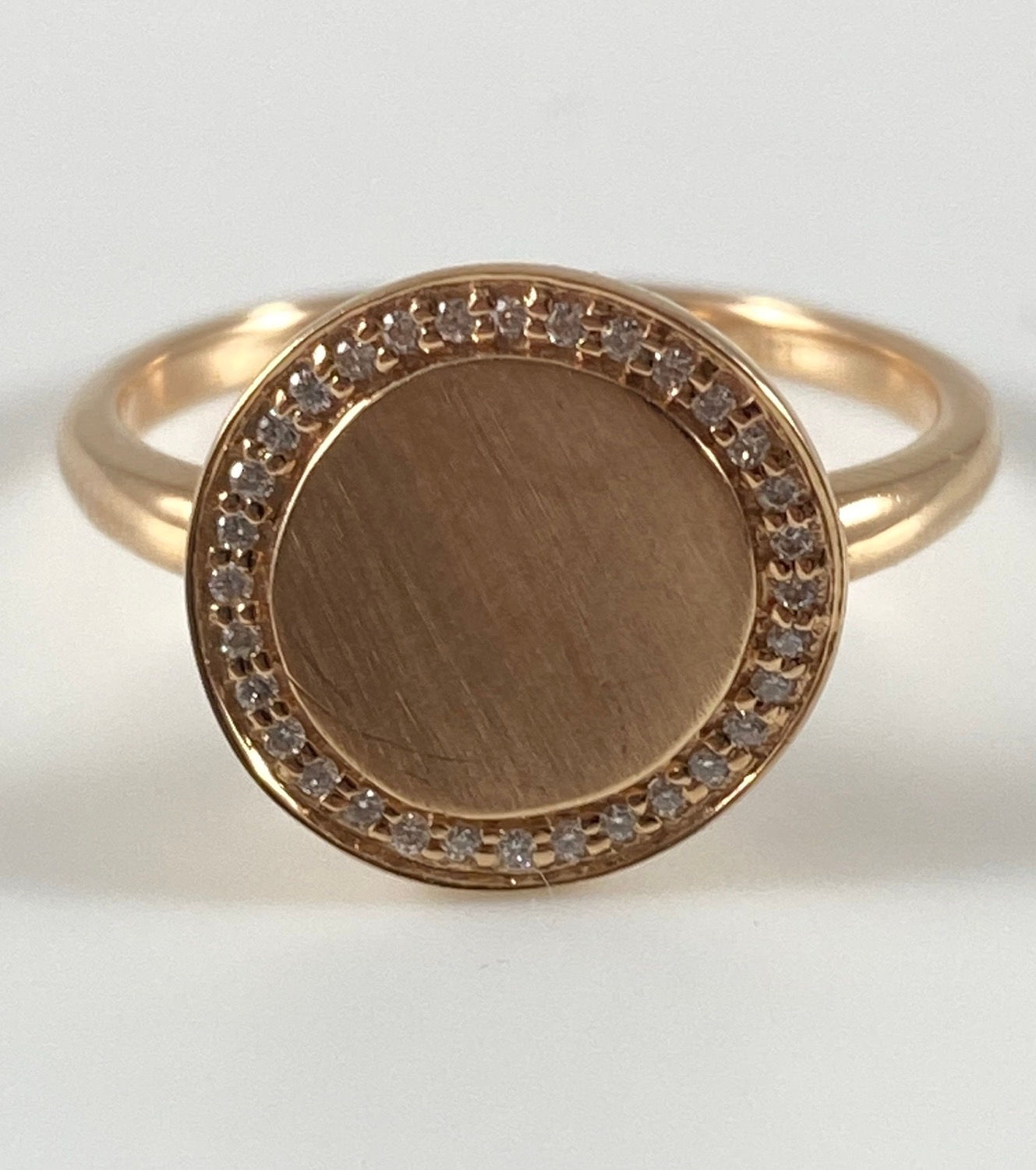 14 karat Rose gold circular ring with .09 ctw of natural round diamonds 