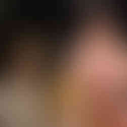 Girl kneels backwards on a chair, hopeful; man dressed as dog kneels beside her, confused