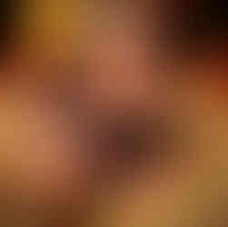 Girl lies on the ground journaling in a brown diary with a feather quill