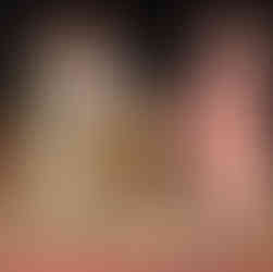 The girl on the right in pink offers her shoe to the girl on the left in green, who is refusing it.