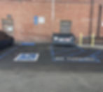 accessible parking space with a dumpster on the access aisle