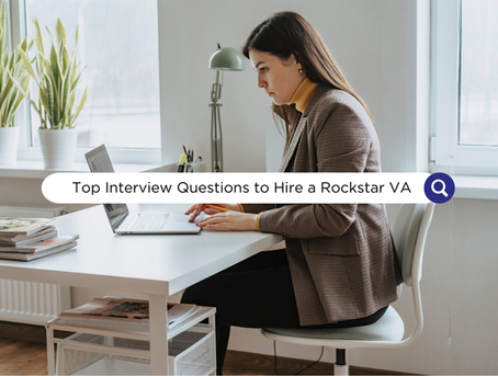 Woman in blazer typing on laptop at a white desk in a bright room. Text overlay: "Top Interview Questions to Hire a Rockstar VA."
