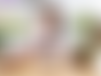 Woman in apron writing at desk with laptop, surrounded by flowers and craft supplies. Text: How a VA for a Florist Can Help Your Business Bloom.