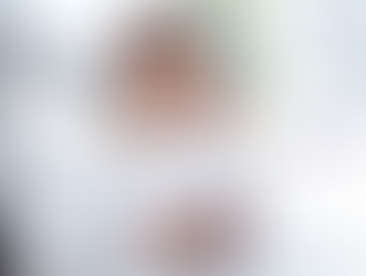 Man in white shirt smiling, on a phone call while using a laptop. Text overlay: "How to Onboard a VA in Under 30 Days." Bright office setting.