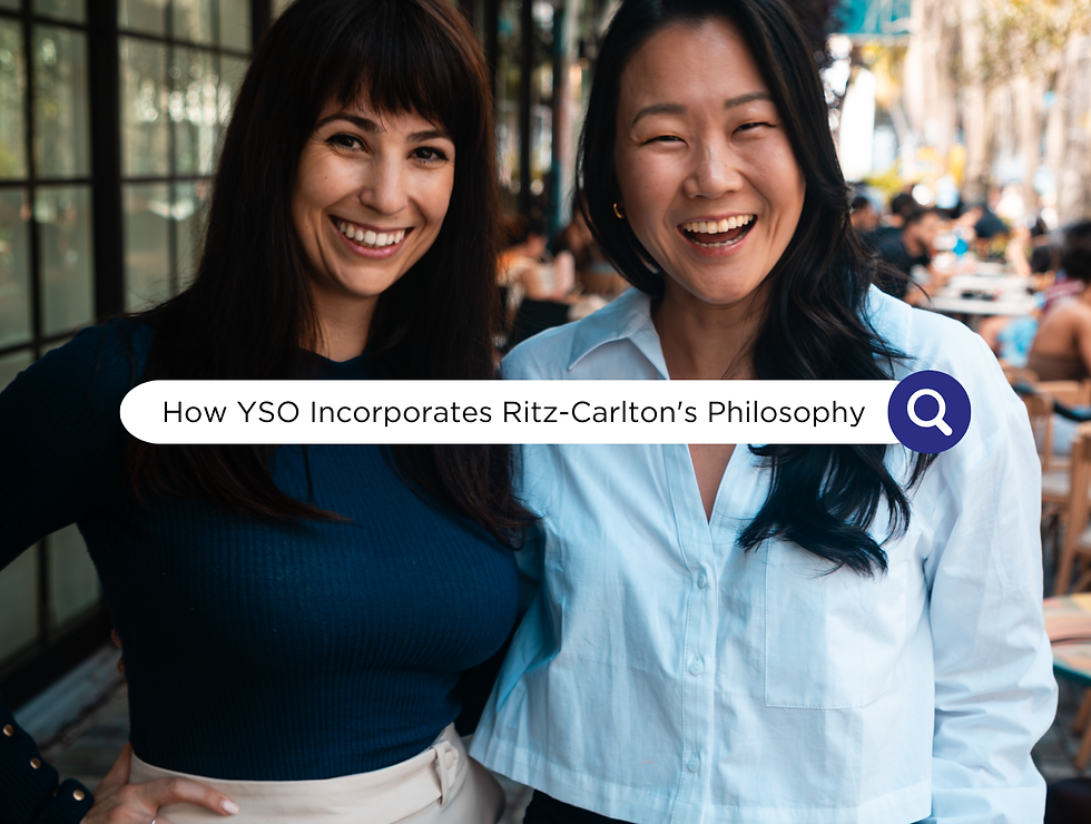 Two smiling women pose outdoors at a cafe, with a search bar reading How YSO Applies the Ritz-Carlton’s Philosophy.