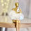 Thumbnail: Close-up of gold figurines with cloud bases and fairy lights