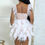 Thumbnail: Back view of the Feather Theory sequin mini dress featuring dramatic white feather trim and a fitted silhouette.