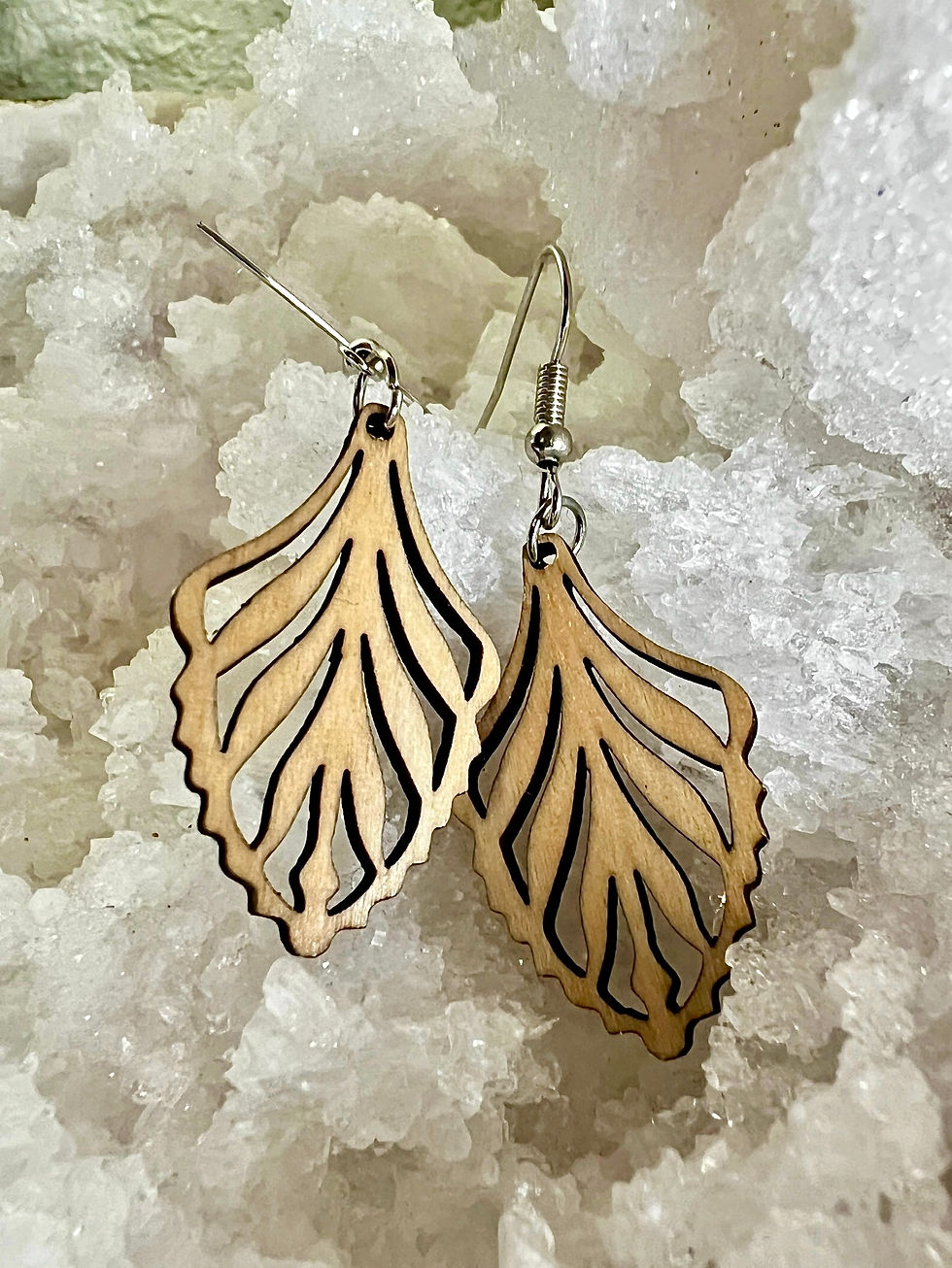 Eye-level view of bold earrings hanging on a stand