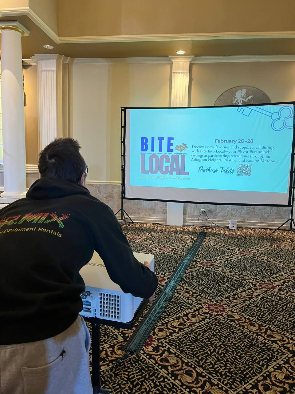 Close-up view of our AV technician fine-tuning the projector image on the screen