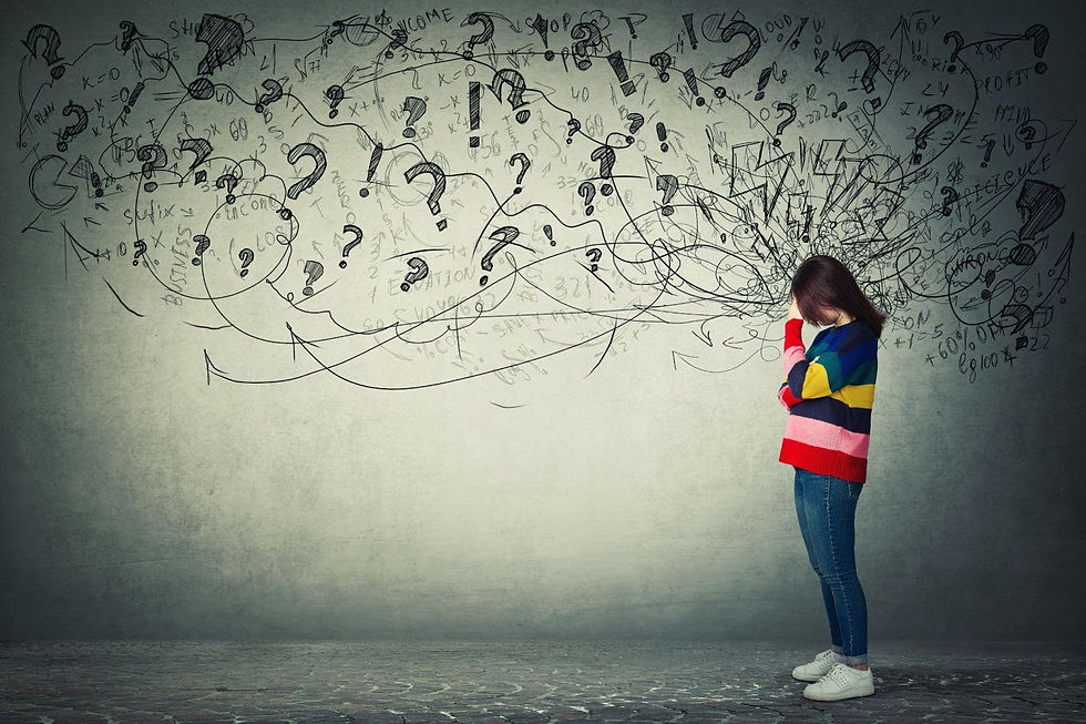 Woman in colorful sweater stands with head in hands, surrounded by chaotic doodles on gray wall, conveying stress and confusion.