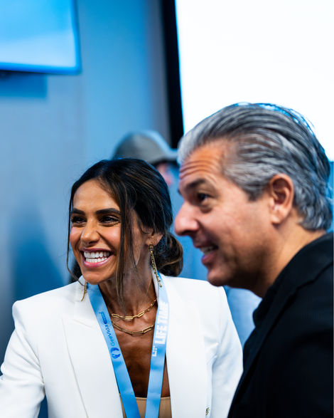 Smiling woman and man, happy in discussion, wearing business attire, talking.