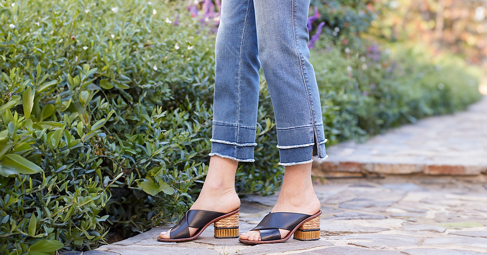 Close-up of Democracy Clothing cropped jeans with layered raw hems styled with block heel sandals.