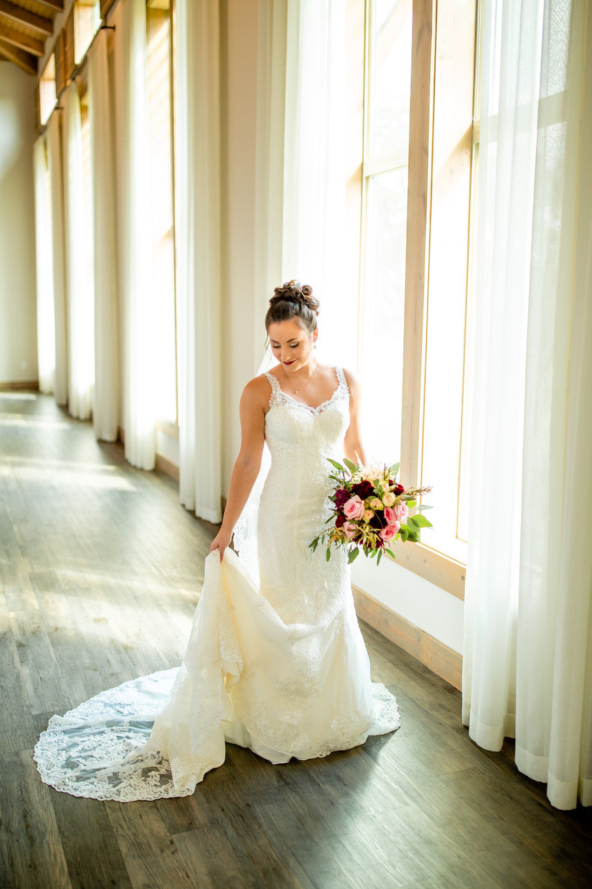 fit and flare lace wedding gown with rose bouquet