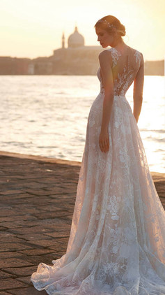 Wedding dress with a modern, finely-embroidered lace design. The tattoo look on the button-up back completes this dreamy look! Nicole Milano Ombretta