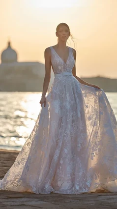 Wedding dress with a modern, finely-embroidered lace design. The tattoo look on the button-up back completes this dreamy look! Nicole Milano Ombretta
