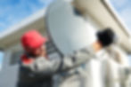 Service worker installing and fitting satellite antenna dish for cable TV.jpg