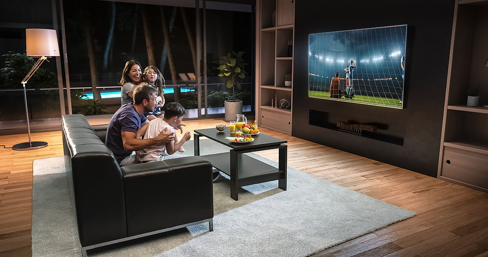 A family is watching a soccer moment on the TV and celebrating a goal, sitting on the couc