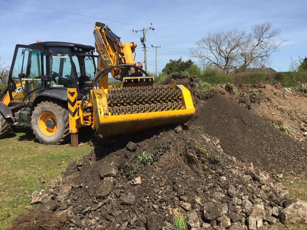 Gyru-Star screening bucket on a backhoe loader