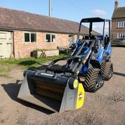 A Gyru-Star screening bucket on a tracked compact loader