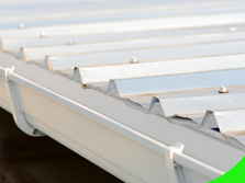 Close-up of a metal roof with attached rain gutter.