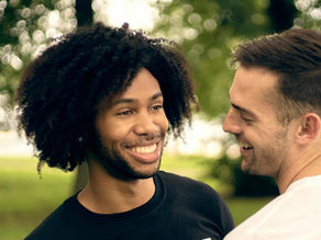 Two guys smiling at each other