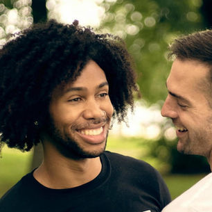 Two guys smiling at each other