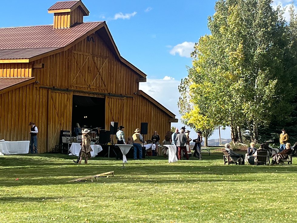 Rustic Barn Wedding Venue with spacious lawn for yard games.  Band is set up in the front of the barn, with cocktail tables and fire pits.