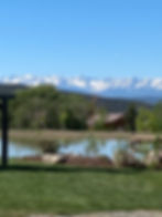 Breath taking view from Antler Ridge Weddings located near Grand Junction , Colorado. The pond is also the backdrop for the ceremony site. Snow capped mountains can be seen in early May and late Fall.
